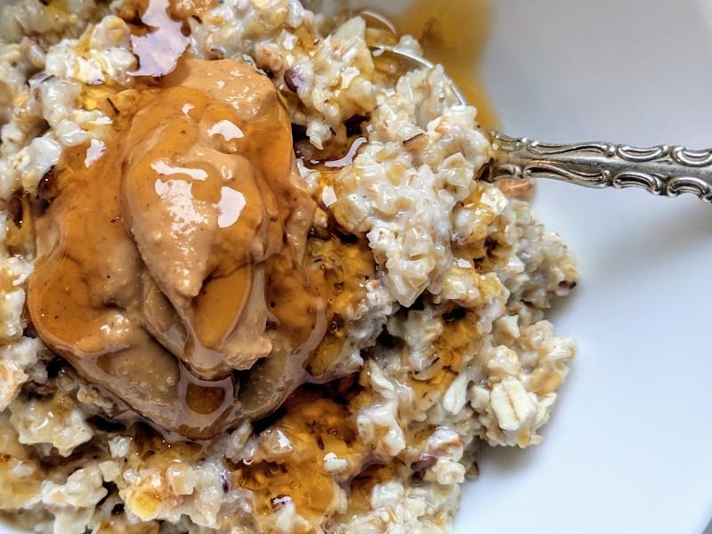Rolled oats, peanut butter, honey, and chocolate chips arranged on a kitchen counter, ready for mixing